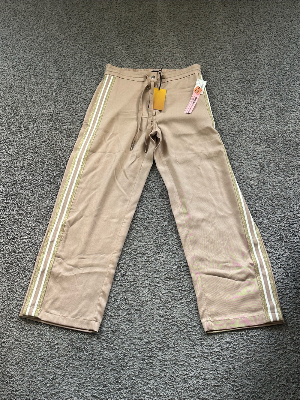 Le Superbe women’s On Track Pants in creamy tan and gold, snap hem